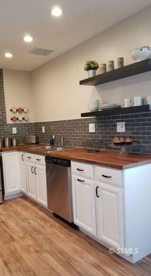727 North Sanders Street Ridgecrest, CA 93555 - Photo 22 of 27 a kitchen with granite countertop a sink and cabinets