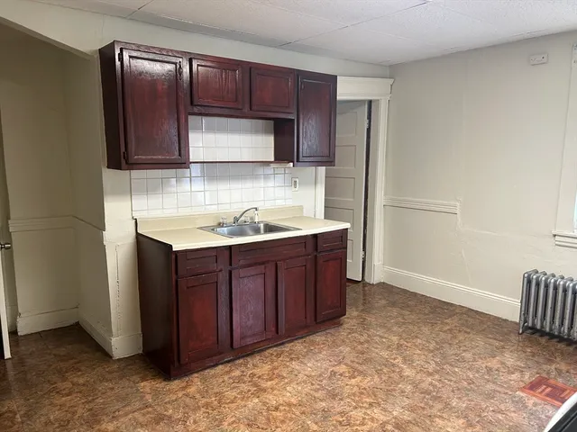 a kitchen with a sink and a refrigerator