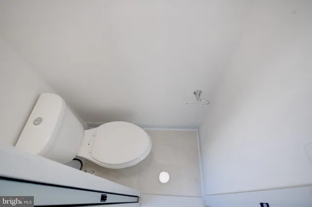 an empty room with a window and a ceiling fan