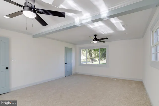 a view of a livingroom with a ceiling fan and window