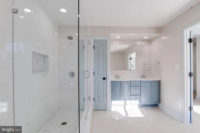 an empty room with windows ceiling fan and window
