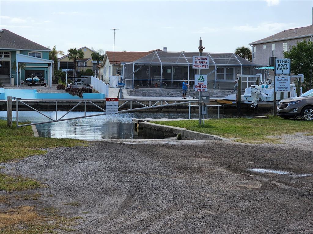 143 Inwood Drive Hudson, FL 34667 - Photo 8 of 20 a front view of residential houses with yard and parking