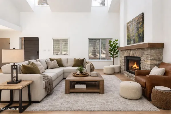 a living room with furniture and a fireplace