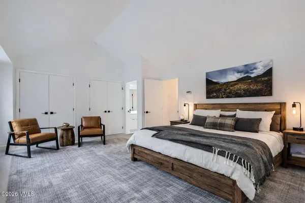 a bedroom with bed and a couch
