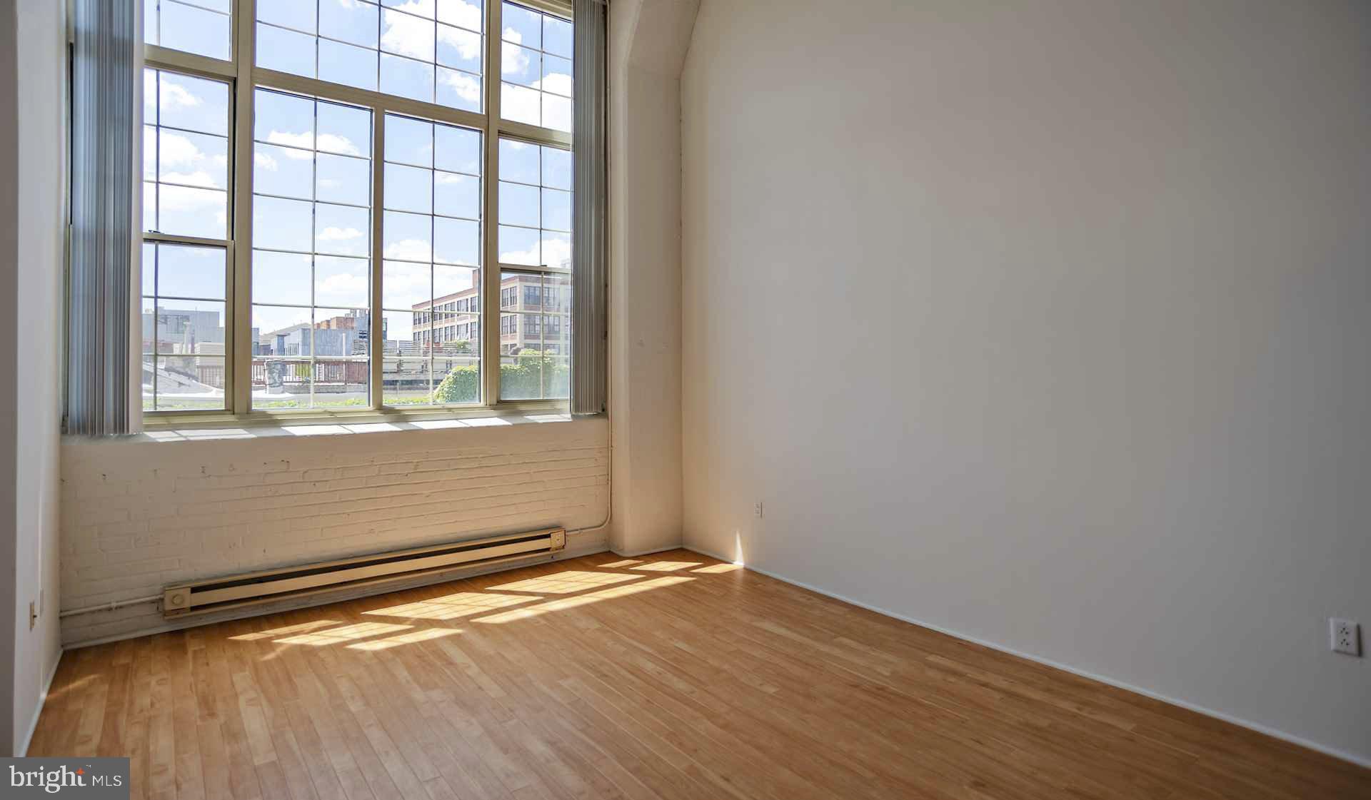 2300 Walnut Street, Unit 0B521 Philadelphia, PA 19103 - Photo 23 of 28 an empty room with wooden floor and windows
