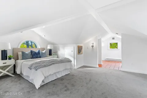 a front view of a house with a garden and yard