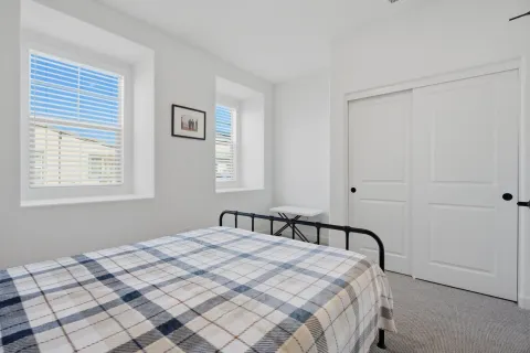 a bedroom with a bed and a window