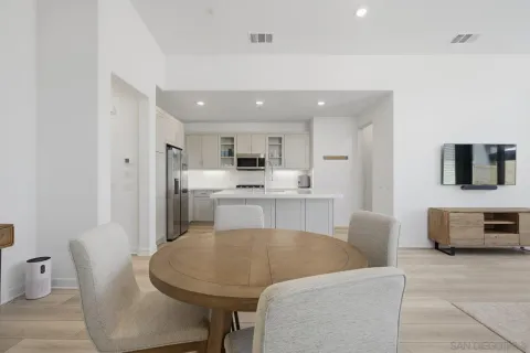 a living room with furniture and kitchen view