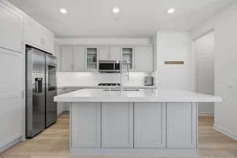a kitchen with stainless steel appliances a sink and refrigerator