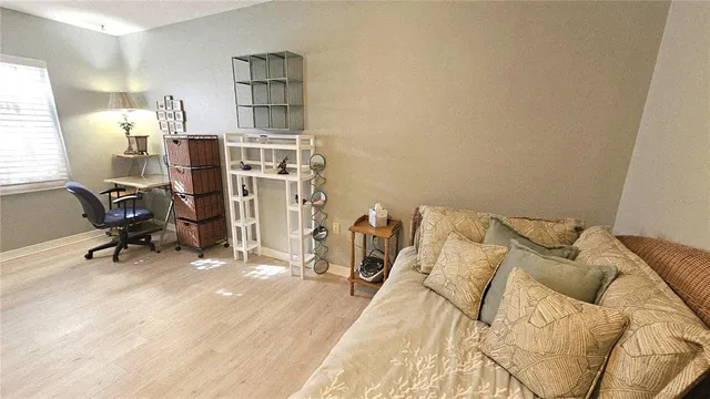 a bed room with a bed and a chair