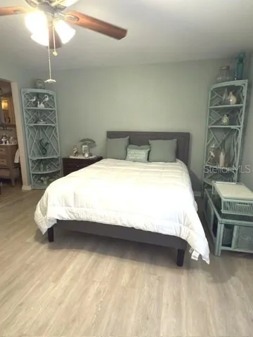 a large bed sitting in a room next to a lamp and a table