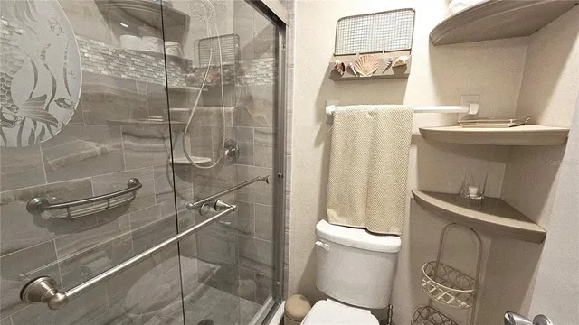 a bathroom with a shower toilet and sink
