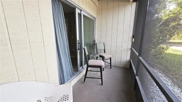 a view of a hallway with furniture and a window