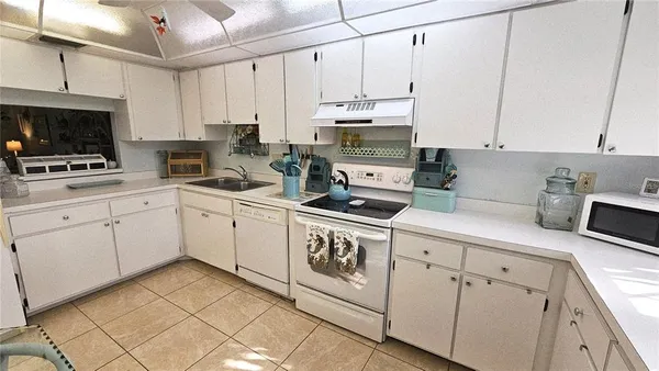 a kitchen with appliances cabinets and a sink