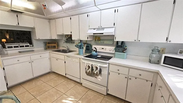 a kitchen with appliances cabinets and a sink