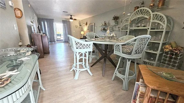 a dining room with furniture a chandelier and wooden floor