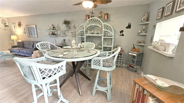 a view of a dining room with furniture a chandelier and wooden floor