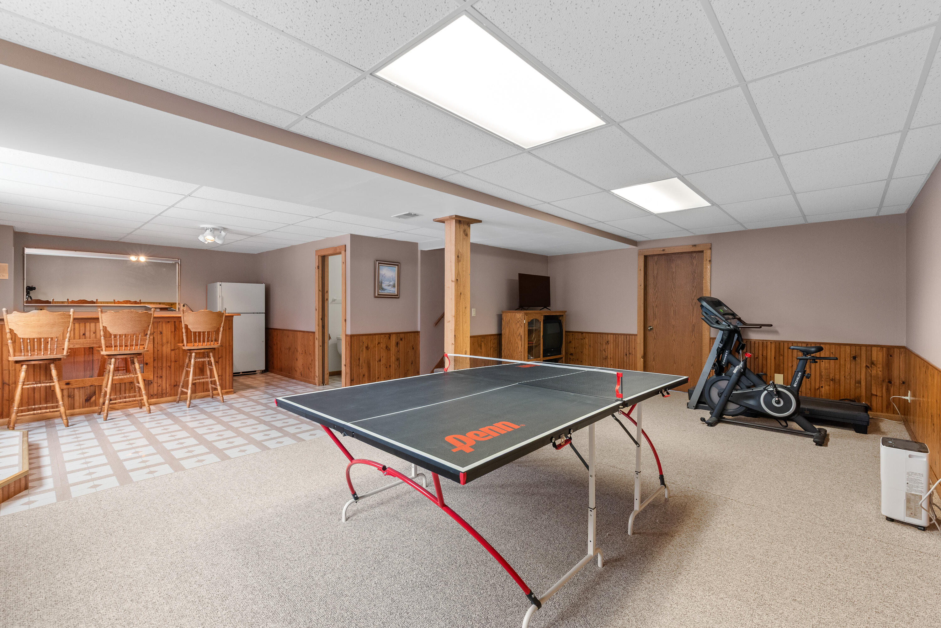 W1072 Hilltop Road Rubicon, WI 53078 - Photo 33 of 51 Large L shaped space with rec room space, game room space & bar area.