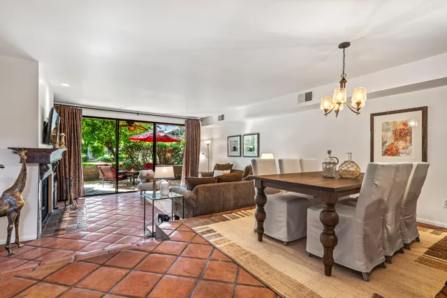 a living room with furniture a rug and a large window