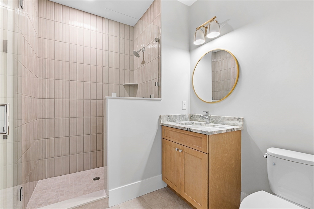 78 Morningside Road Needham, MA 02492 - Photo 16 of 38 a bathroom with a granite countertop toilet sink and mirror