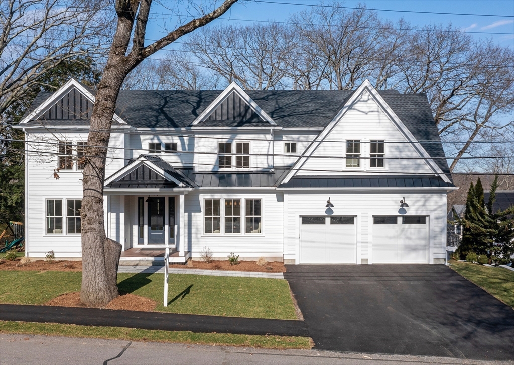 78 Morningside Road Needham, MA 02492 - Photo 2 of 38 a view of a white house with large windows and a table and chairs