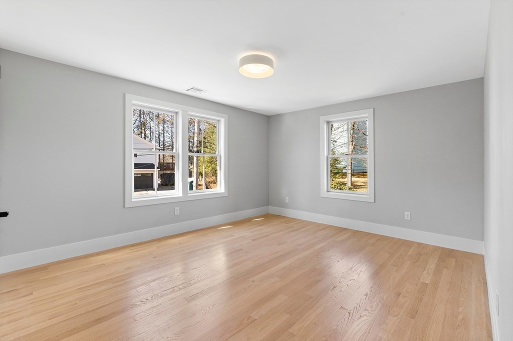 78 Morningside Road Needham, MA 02492 - Photo 22 of 38 a view of an empty room with a window and wooden floor