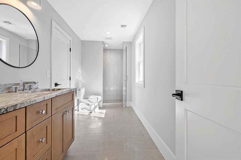 78 Morningside Road Needham, MA 02492 - Photo 26 of 38 a bathroom with a granite countertop double vanity sink and a mirror