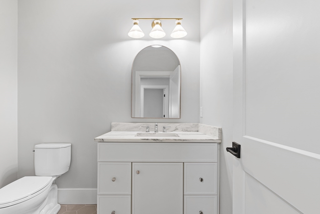 78 Morningside Road Needham, MA 02492 - Photo 33 of 38 a bathroom with a toilet sink vanity and mirror