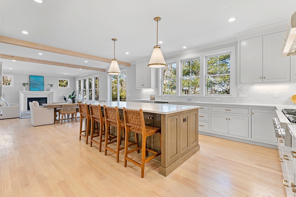 78 Morningside Road Needham, MA 02492 - Photo 6 of 38 a kitchen with stainless steel appliances kitchen island granite countertop a stove a sink a dining table and chairs