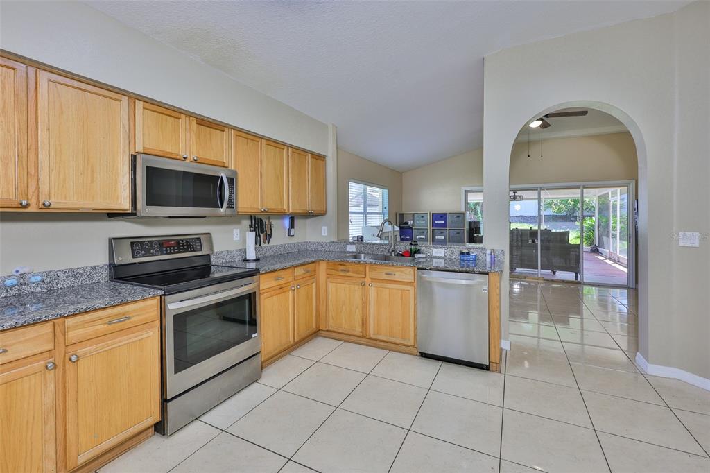 2613 Thames River Place Valrico, FL 33596 - Photo 14 of 41 a kitchen with a stove a sink and a microwave