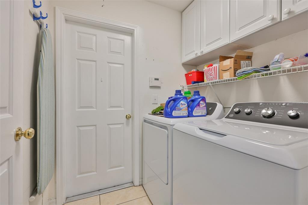 2613 Thames River Place Valrico, FL 33596 - Photo 18 of 41 a kitchen with white cabinets and white appliances