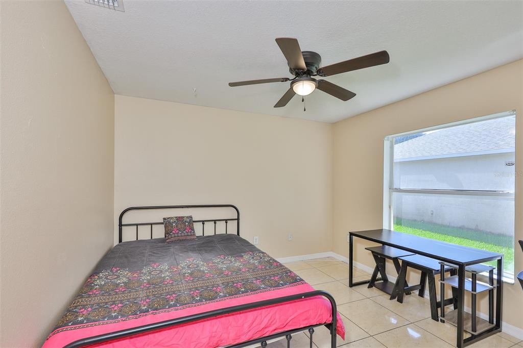 2613 Thames River Place Valrico, FL 33596 - Photo 19 of 41 a bedroom with a bed and a chandelier