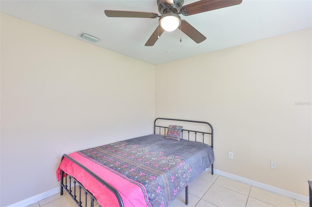 2613 Thames River Place Valrico, FL 33596 - Photo 20 of 41 a bedroom with a bed and a chandelier fan