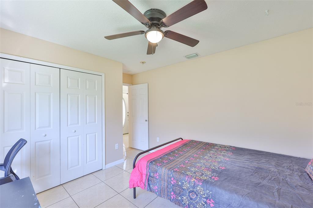 2613 Thames River Place Valrico, FL 33596 - Photo 21 of 41 a bedroom with a bed and a chandelier