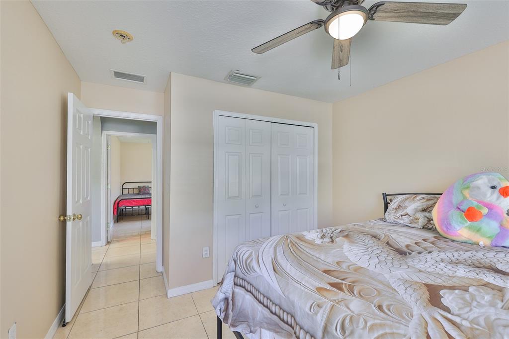 2613 Thames River Place Valrico, FL 33596 - Photo 24 of 41 a bedroom with a bed and cabinets