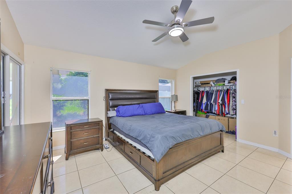 2613 Thames River Place Valrico, FL 33596 - Photo 27 of 41 a bedroom with a bed and a chandelier