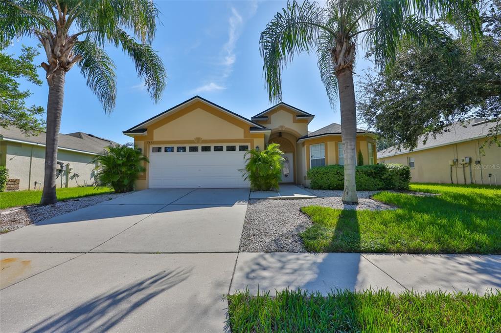 2613 Thames River Place Valrico, FL 33596 - Photo 3 of 41 a view of a house with a yard and palm trees