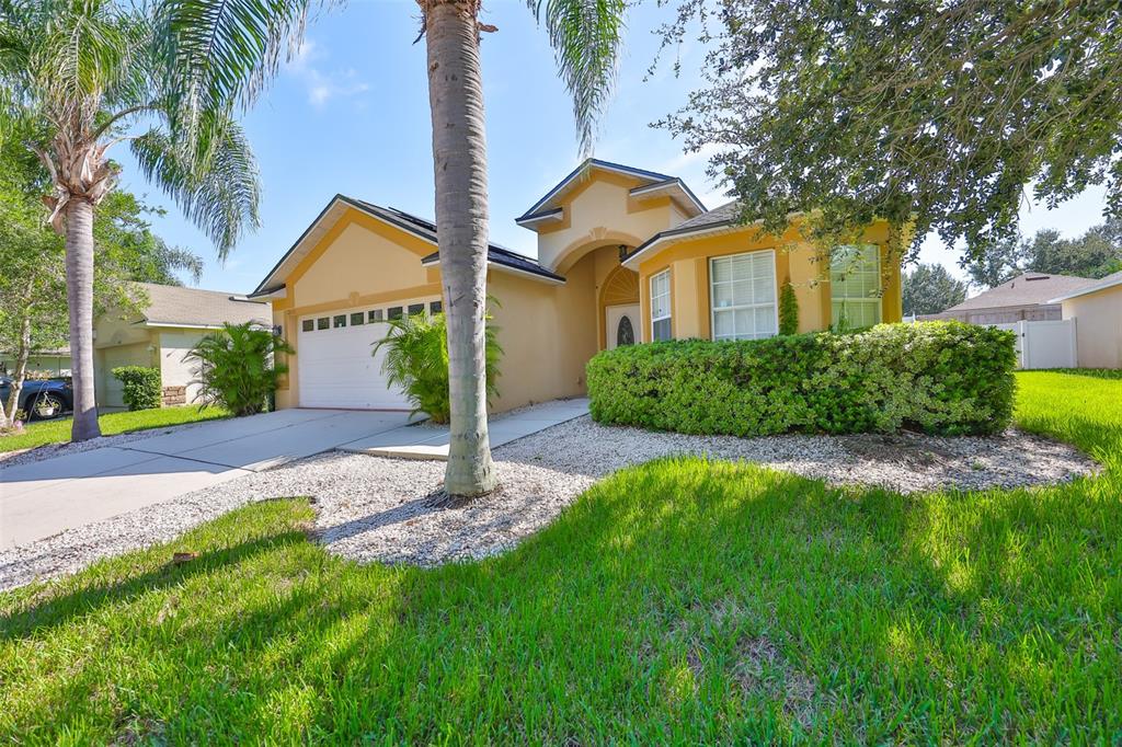 2613 Thames River Place Valrico, FL 33596 - Photo 4 of 41 a front view of a house with a yard and garage