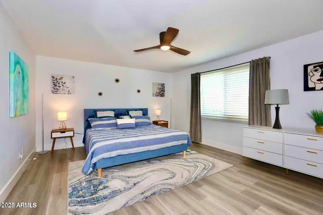 a bedroom with a bed and a dresser