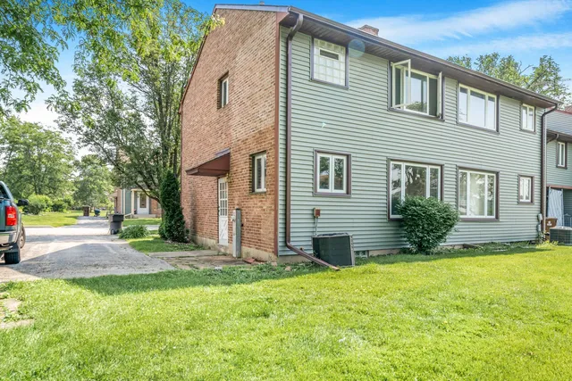 a view of a house with a yard and tree s