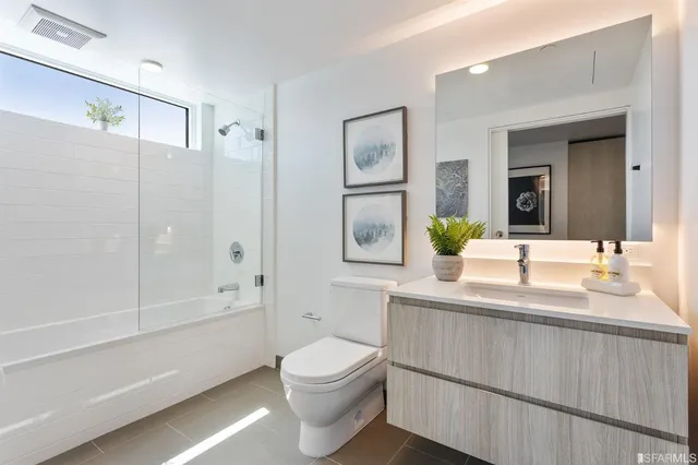 a bathroom with bathtub and shower