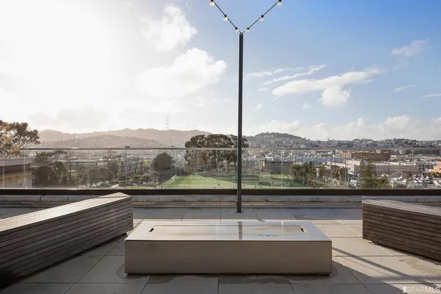 a view of a balcony with wooden floor and outdoor seating