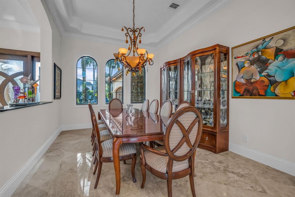 7328 Ballantrae Court Boca Raton, FL 33496 - Photo 24 of 89 a view of a dining room with furniture and chandelier