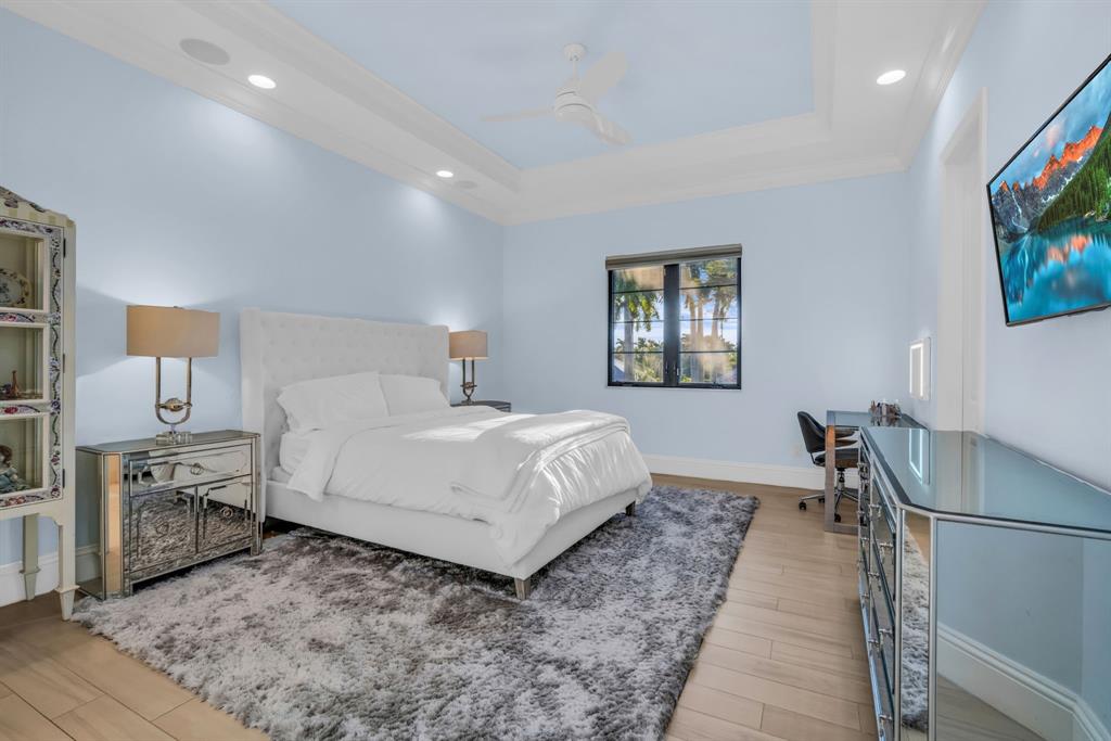 7328 Ballantrae Court Boca Raton, FL 33496 - Photo 45 of 89 a spacious bedroom with a bed and a flat screen tv