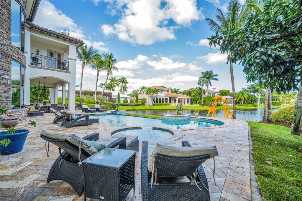 7328 Ballantrae Court Boca Raton, FL 33496 - Photo 76 of 89 a view of a swimming pool with lawn chairs and a big yard