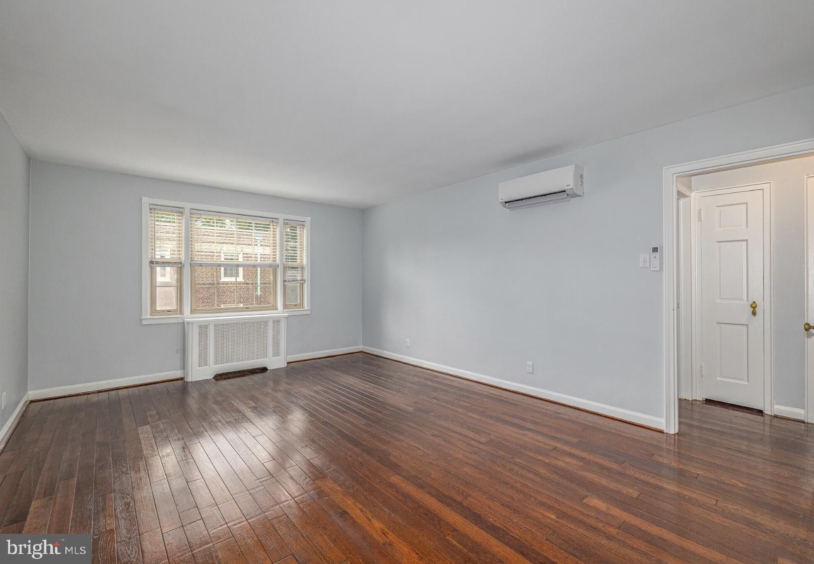 150 East Wynnewood Road, Unit 19F Wynnewood, PA 19096 - Photo 8 of 11 an empty room with wooden floor and windows