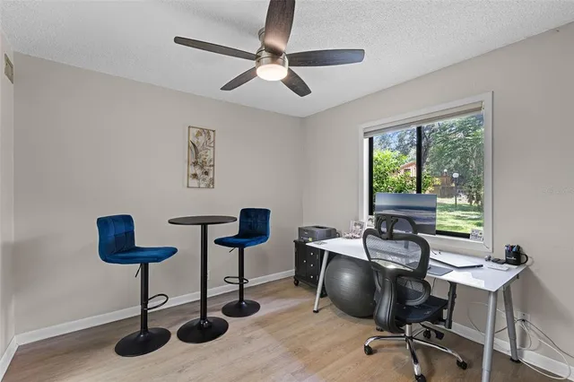 a workspace with furniture and a large window
