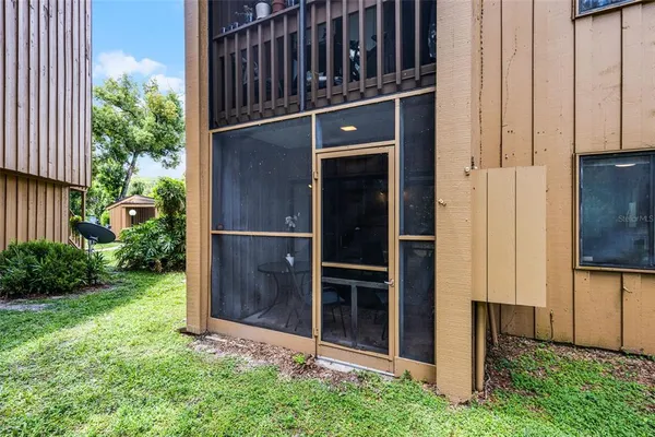 a backyard of a house with plants and wooden fence