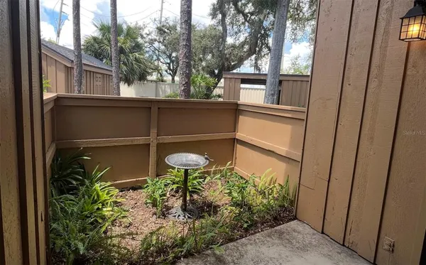 a backyard of a house with a fountain