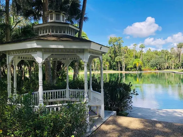 a view of a house with a yard next to a lake
